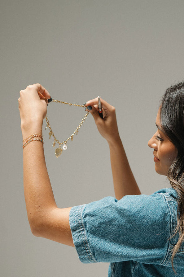 Woman holding a charm necklace